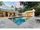Large inground pool with travertine deck, connecting colonnade, sun loungers and a covered outdoor dining area at 608 E Club Cir, Longwood, FL 32779