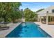Lush backyard featuring a refreshing pool, lounge area, and landscaping at 608 E Club Cir, Longwood, FL 32779