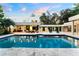 Beautiful pool with lounge chairs and lush greenery surrounding the backyard at 608 E Club Cir, Longwood, FL 32779