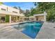 Wide view of the sparkling pool, backyard, covered patio, and modern home exterior at 608 E Club Cir, Longwood, FL 32779