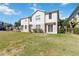 Spacious lawn area behind attached townhome featuring sliding glass door at 6434 S Goldenrod Rd # 17B, Orlando, FL 32822