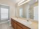 Bathroom with double sinks, shower and a window with horizontal blinds at 6434 S Goldenrod Rd # 17B, Orlando, FL 32822