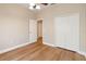 Bedroom with wood-look floors, ceiling fan, and bi-fold closet, offering ample storage at 6434 S Goldenrod Rd # 17B, Orlando, FL 32822
