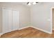 Bedroom with wood-look floors, bi-fold closet, and light-colored walls at 6434 S Goldenrod Rd # 17B, Orlando, FL 32822