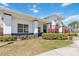 Clubhouse with a covered entry, well-kept landscaping, and neutral tones at 6434 S Goldenrod Rd # 17B, Orlando, FL 32822