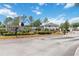 Carter Glen community entrance with manicured landscaping and a secure gated entry on a bright, sunny day at 6434 S Goldenrod Rd # 17B, Orlando, FL 32822
