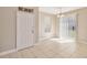 Entryway with neutral tile flooring, white door, and light fixtures, creating a bright and welcoming space at 6434 S Goldenrod Rd # 17B, Orlando, FL 32822