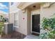 Image shows the home's front entrance and door, with adjacent window, AC unit, and greenery at 6434 S Goldenrod Rd # 17B, Orlando, FL 32822