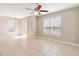 View of a spacious living room with ceiling fan, sliding glass doors, and adjacent dining area at 6434 S Goldenrod Rd # 17B, Orlando, FL 32822