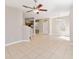 An open-concept living space featuring neutral walls, staircase, and view into the kitchen area at 6434 S Goldenrod Rd # 17B, Orlando, FL 32822