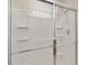 Bathroom with a glass shower that includes a chrome shower head and shelving at 6434 S Goldenrod Rd # 17B, Orlando, FL 32822