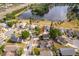 Aerial view of the property and surrounding neighborhood near a lake at 645 Upperriver Ct, Orlando, FL 32828