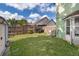 Fenced backyard with green grass and shed at 645 Upperriver Ct, Orlando, FL 32828