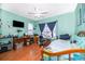 Bright bedroom with a ceiling fan, wood-look flooring, and desk space at 645 Upperriver Ct, Orlando, FL 32828