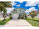 Inviting two-story home with a well-manicured lawn, concrete driveway, and attached garage at 645 Upperriver Ct, Orlando, FL 32828