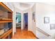 Hallway leads to bedrooms, features wood floors, and ample natural light at 645 Upperriver Ct, Orlando, FL 32828