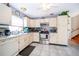 Spacious kitchen with tile flooring, bright light, stainless steel appliances, and ample storage at 645 Upperriver Ct, Orlando, FL 32828