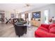 Open living room with tile flooring, comfortable seating, bright light, and view to dining area at 645 Upperriver Ct, Orlando, FL 32828
