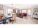 Open living room with tile flooring, comfortable seating, bright light, and view to dining area at 645 Upperriver Ct, Orlando, FL 32828