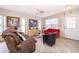 Bright living room with tile flooring, fan, comfortable seating, and a view to the outside at 645 Upperriver Ct, Orlando, FL 32828