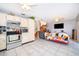 Open floor plan showcasing the kitchen with stainless steel appliances and a spacious living area at 645 Upperriver Ct, Orlando, FL 32828