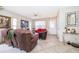 Bright living room with tile flooring, fan, comfortable seating, and a view to the outside at 645 Upperriver Ct, Orlando, FL 32828