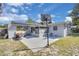 Spacious backyard featuring a basketball hoop, screened-in porch, and a concrete patio perfect for outdoor activities at 6464 Inca St, Orlando, FL 32807