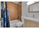 Stylish bathroom with wood-look tile shower, modern vanity, and updated fixtures at 6464 Inca St, Orlando, FL 32807