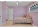 Bright bedroom featuring tile floors, a ceiling fan, and neutral-colored walls at 6464 Inca St, Orlando, FL 32807