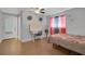 Nicely decorated bedroom with wood-look floors, a ceiling fan, and a writing desk at 6464 Inca St, Orlando, FL 32807