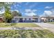 Charming single-story home with a carport, well-maintained lawn, and mature trees at 6464 Inca St, Orlando, FL 32807