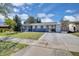 Charming single story home with a carport and a cozy screened in front porch and well-maintained front yard at 6464 Inca St, Orlando, FL 32807