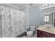 Well-maintained bathroom featuring a shower with a floral curtain at 6857 Dolce St, Orlando, FL 32819