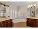 Bright bathroom features a soaking tub, dual vanities, and tiled accents at 6857 Dolce St, Orlando, FL 32819