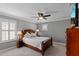 Cozy bedroom with a ceiling fan and shuttered windows at 6857 Dolce St, Orlando, FL 32819