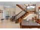 Spacious dining area with staircase and chandelier, offering an elegant space for meals and gatherings at 6857 Dolce St, Orlando, FL 32819