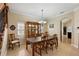 Dining room with a staircase and classic furniture, featuring a china cabinet for storage and display at 6857 Dolce St, Orlando, FL 32819