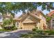 Two-story home with lush front yard landscaping and brick paver driveway, with a classic red-tile roof at 6857 Dolce St, Orlando, FL 32819