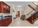 Grand foyer featuring a bar area, staircase, and a view into the living area with decorative flooring at 6857 Dolce St, Orlando, FL 32819
