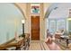 Inviting foyer with decorative glass feature above the door, leading into a living area at 6857 Dolce St, Orlando, FL 32819