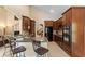 Open kitchen features wooden cabinets, breakfast bar, and stainless steel appliances at 6857 Dolce St, Orlando, FL 32819