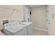 Practical laundry room with washer, dryer, and storage shelves at 6857 Dolce St, Orlando, FL 32819