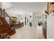 Open-concept living area with staircase, fireplace, dining table, and access to the living room at 6857 Dolce St, Orlando, FL 32819