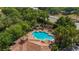 Aerial view of pool and recreation area featuring surrounding lounge seating and mature palm trees at 6857 Dolce St, Orlando, FL 32819