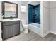Updated bathroom with stylish vanity, toilet, and bath tub with blue tiled shower at 7507 Duo Lakes Dr, Orlando, FL 32810