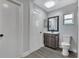 Modern bathroom featuring updated vanity, toilet, and a window for natural light at 7507 Duo Lakes Dr, Orlando, FL 32810