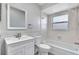 Bright bathroom with a tub, shower, a vanity and classic wainscoting at 7507 Duo Lakes Dr, Orlando, FL 32810