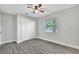 Bright bedroom with ceiling fan, large window, and a double door closet at 7507 Duo Lakes Dr, Orlando, FL 32810