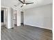 Spacious bedroom with light gray walls, ceiling fan, and several entry doors at 7507 Duo Lakes Dr, Orlando, FL 32810