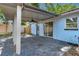 Covered patio featuring gray pavers, ceiling fan, and access to home via sliding glass door at 7507 Duo Lakes Dr, Orlando, FL 32810